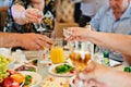 hands with glasses of drinks above the festive table. Royalty Free Stock Photo