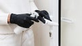hands with gloves disinfecting door handle. High quality photo Royalty Free Stock Photo