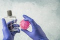 Hands in gloves holding cologne bottle to disinfection virus Royalty Free Stock Photo