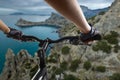 Hands in gloves holding handlebar of a bicycle. Mountain Bike cyclist riding single track. Healthy lifestyle active athlete doing