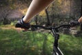 Hands in gloves holding handlebar of a bicycle. Mountain Bike cyclist riding single track. Healthy lifestyle active athlete doing Royalty Free Stock Photo