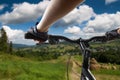 Hands in gloves holding handlebar of a bicycle Royalty Free Stock Photo