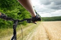 Hands in gloves holding handlebar of a bicycle. Mountain Bike cyclist riding single track. Healthy lifestyle active Royalty Free Stock Photo