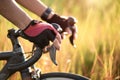 Hands in gloves holding road bicycle handlebar. Sports and outdoor activities concept