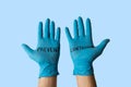 Hands with gloves with written on it prevent the infection. Health prevention and safety concept