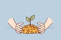 Hands with gold coins and growing tree symbolizing dividends on accumulated capital