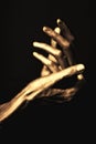 Hands in golden paint on black background Royalty Free Stock Photo