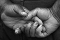 Hands of a grandfather black and white crossed fingers elderly