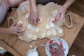 Hands of grandmother and girl, coocking dough for dumplings with meat