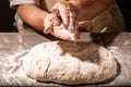 Hands of granny kneads dough. 80 years old woman hands kneading dough. Grandmother dough molding on table. homemade baking. Pastry Royalty Free Stock Photo