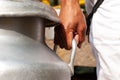 Hands grasping a pitcher of milk with their hands