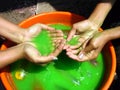 Hands in green Holi water