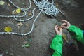 Hands in green sleeves on a background of a climber rope.