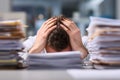 Hands Gripping Head Over Desk Piles of Documents Royalty Free Stock Photo
