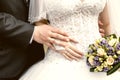 Hands of groom and bride close-up and bridal bouquet Royalty Free Stock Photo