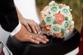 Hands of groom and bride with rings and a wedding bouquet Royalty Free Stock Photo