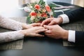 Hands of groom and bride with rings and a beautiful wedding bouquet Royalty Free Stock Photo