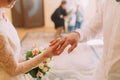 Hands of the groom and bride wearing ring on finger, wedding ceremony in registry office, close-up Royalty Free Stock Photo