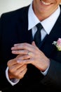 Hands, groom man and ring for wedding, celebration and commitment to relationship, smile and pride. Person, metal