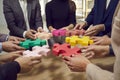 Hands of a group of business people assembling jigsaw puzzle. Cooperation, teamwork support concept Royalty Free Stock Photo