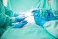 Hands of a group of surgeons at work