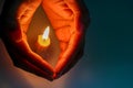 Hands guarding candle flame , protective , selfe care, caring , love theme Royalty Free Stock Photo