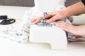 Sewing fabric with a sewing machine in a bright workspace during daytime Royalty Free Stock Photo