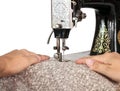 Hands guiding fabric through a vintage sewing machine Royalty Free Stock Photo