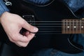 Hands of guitarist with an electric guitar pick. Abstract music background
