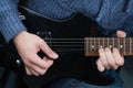 Hands of guitarist with an electric guitar pick. Abstract music background