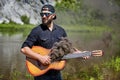 One young man holds a guitar that smokes