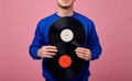 A hands of guy in dark blue jacket holds two black vinyl records Royalty Free Stock Photo