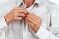 Hands a guy unbutton his bright shirt closeup Royalty Free Stock Photo