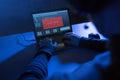 Hands of hacker with access denied message laptop