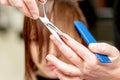 Hairdresser cuts hair of woman Royalty Free Stock Photo