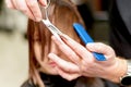 Hairdresser cuts hair of woman Royalty Free Stock Photo