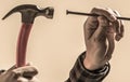 Hands with hammesr and nail. Hammering a nails, hands only. Hammer hand nail Royalty Free Stock Photo