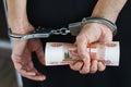 Hands in handcuffs behind, holding five thousand rubles Royalty Free Stock Photo