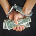 Hands in handcuffs with dollars Royalty Free Stock Photo