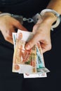 Hands in handcuffs with Russian money