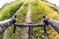 hands on the handlebars of a bicycle of a cyclist riding along a trail in nature. Point of view Royalty Free Stock Photo