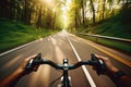 Hands on the handlebars of a bicycle riding on an asphalt road among green trees. Generative AI Royalty Free Stock Photo