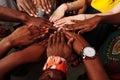 Hands of happy group of multinational African, latin american and european people which stay together in circle Royalty Free Stock Photo