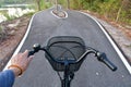 Hands and heads of bicycles coming to a crossroads and having to choose which way