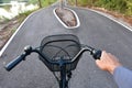 Hands and heads of bicycles coming to a crossroads and having to choose which way