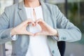 Hands, heart and business woman with love emoji for care, kindness and like review in office. Closeup of female worker