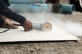 Hands of heavy industry worker with angle grinder cutting concrete. Royalty Free Stock Photo