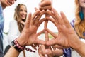 Hands of hippie friends showing peace sign