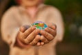 Hands of hispanic woman holding small world ball standing at the city Royalty Free Stock Photo