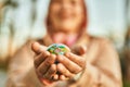 Hands of hispanic woman holding small world ball standing at the city Royalty Free Stock Photo